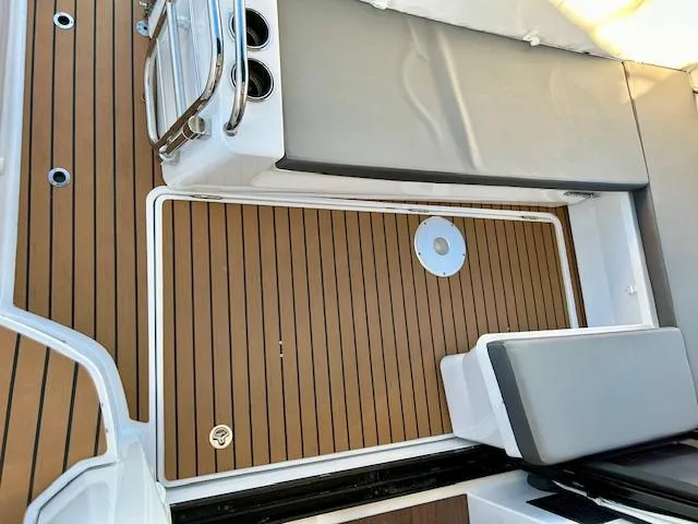 Sea Of Dreams Yacht Photos Pics 2024 Beneteau Antares 9 boat deck with cushioned seating and wood finish.
