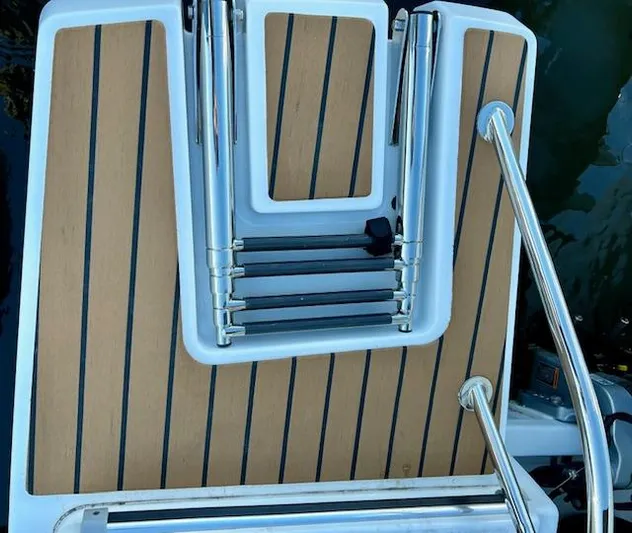 Sea Of Dreams Yacht Photos Pics 2024 Beneteau Antares 9 swim platform with foldable ladder and teak decking.