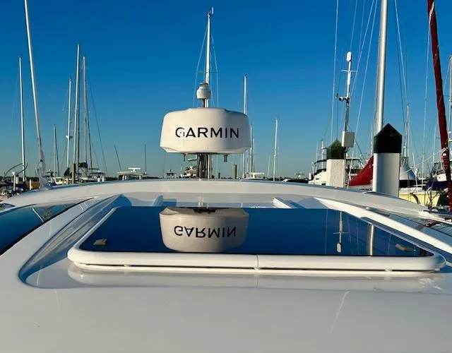 Sea Of Dreams Yacht Photos Pics 2024 Beneteau Antares 9 with Garmin radar, docked in a marina under clear blue skies.