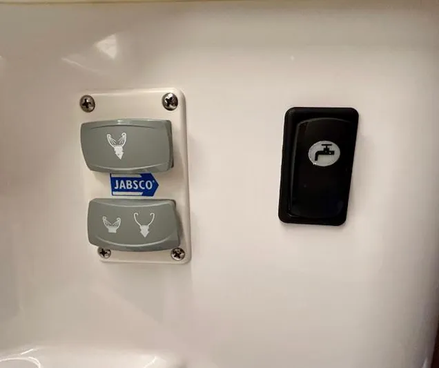 Sea Of Dreams Yacht Photos Pics Control panel with Jabsco switches and faucet icon in 2024 Beneteau Antares 9 boat.