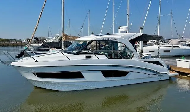 Sea Of Dreams Yacht Photos Pics 2024 Beneteau Antares 9 boat docked in marina, sleek design, white exterior.