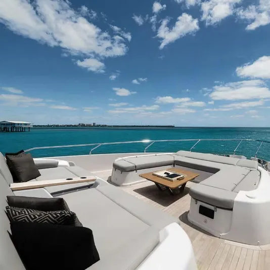 Yacht Photos Pics Luxurious 2025 Ferretti Yachts 860 deck with elegant seating and ocean view.