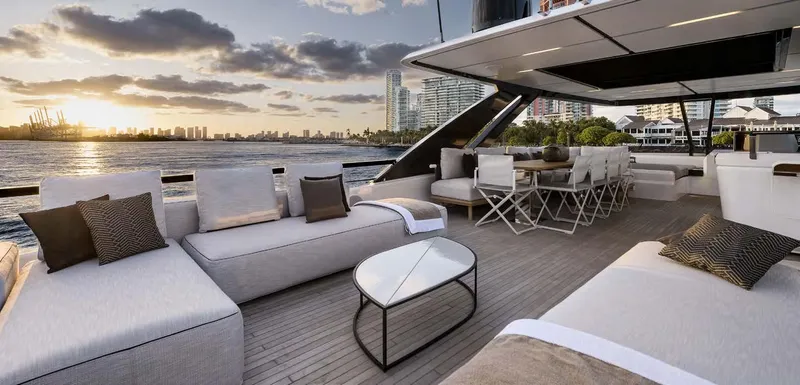  Yacht Photos Pics Luxurious 2025 Ferretti Yachts 860 deck with elegant seating and stunning waterfront view.