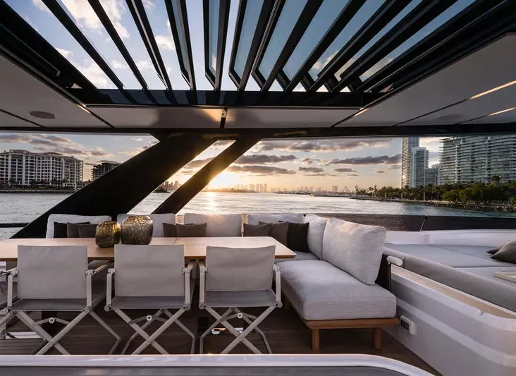  Yacht Photos Pics Luxurious 2025 Ferretti Yachts 860 with elegant outdoor seating and stunning waterfront view.