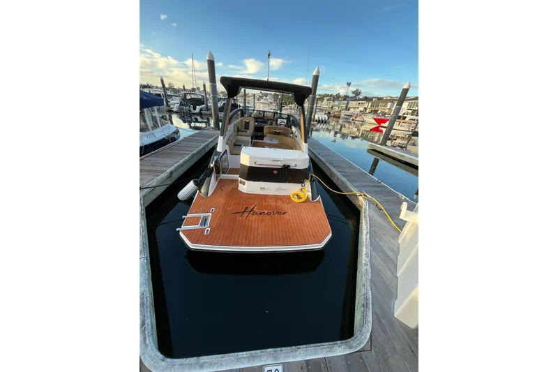  Yacht Photos Pics 2026 Hanover 305 boat docked at marina, featuring sleek design and wooden deck.