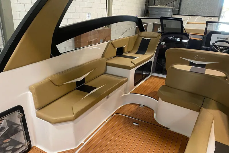  Yacht Photos Pics 2026 Hanover 305 boat interior with tan seating and wood flooring.
