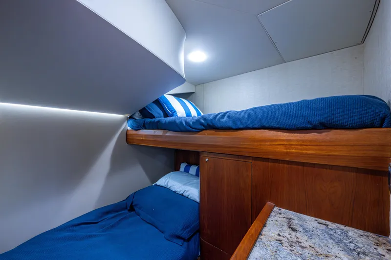 Flying B Yacht Photos Pics Bunk beds in 2018 French Yachts Custom Express Sportfish cabin, featuring blue bedding and wood accents.