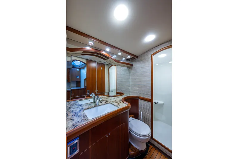Flying B Yacht Photos Pics Luxurious bathroom in 2018 French Yachts Custom Express Sportfish, featuring elegant wood and marble finishes.