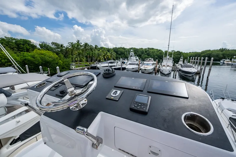Flying B Yacht Photos Pics Control panel of 2018 French Yachts Custom Express Sportfish overlooking marina with boats.