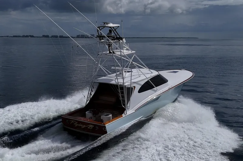 Flying B Yacht Photos Pics 2018 French Yachts Custom Express Sportfish cruising on open water under cloudy skies.