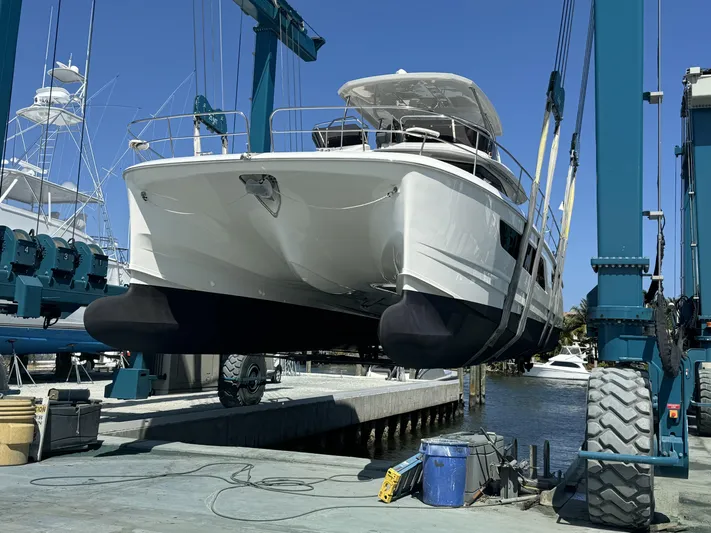 Mojo Yacht Photos Pics Aquila 44 Yacht 2020 in dry dock, suspended by a boat lift.