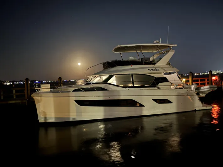 Mojo Yacht Photos Pics 2020 Aquila 44 Yacht docked at night with moonlit reflections.