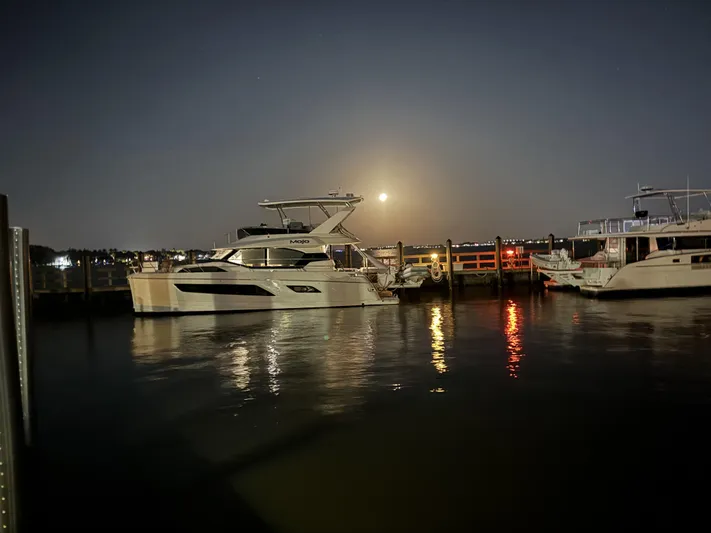 Mojo Yacht Photos Pics Aquila 44 Yacht 2020 docked at night with moonlit reflections on water.