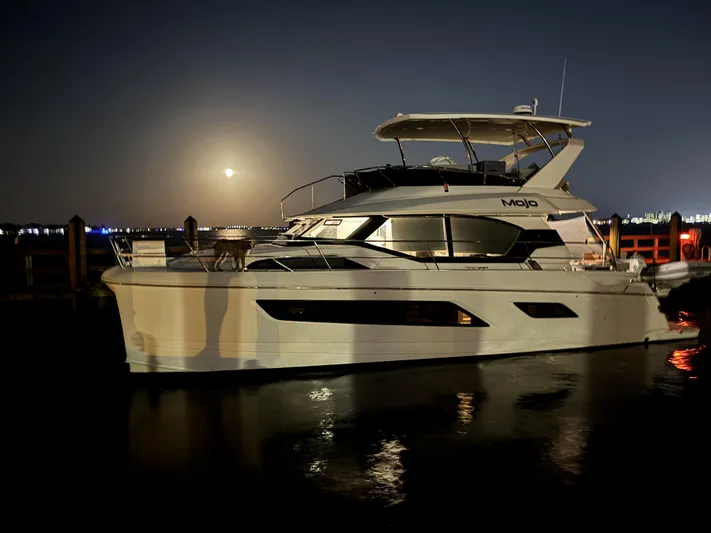 Mojo Yacht Photos Pics Aquila 44 Yacht 2020 docked at night with moonlit reflections on water.