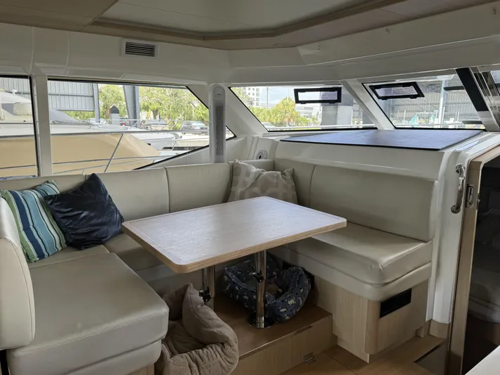 Mojo Yacht Photos Pics Interior of 2020 Aquila 44 Yacht with cozy seating and table.