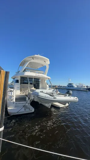 Mojo Yacht Photos Pics Aquila 44 Yacht 2020 docked in sunny marina with clear blue sky.