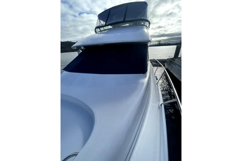 Yeah Buddy Yacht Photos Pics 2001 Bayliner 3988 Command Bridge Motoryacht on calm water under cloudy sky.