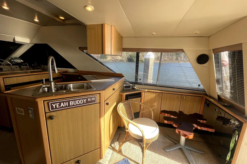 Yeah Buddy Yacht Photos Pics 2001 Bayliner 3988 Command Bridge Motoryacht interior with kitchen and seating area.
