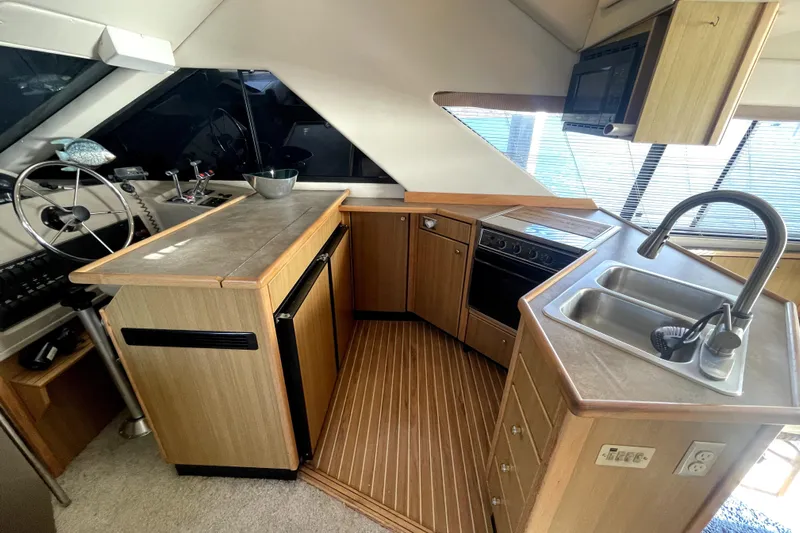 Yeah Buddy Yacht Photos Pics Interior of 2001 Bayliner 3988 Command Bridge Motoryacht with kitchen and helm station.
