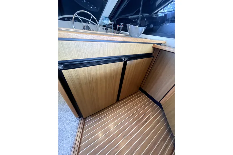 Yeah Buddy Yacht Photos Pics 2001 Bayliner 3988 Command Bridge Motoryacht interior with wood cabinetry and steering wheel.