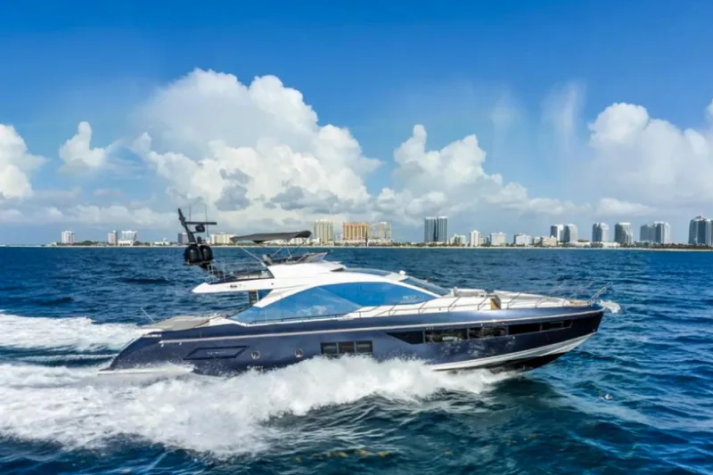 No Name Yacht Photos Pics 2019 Azimut S7 yacht cruising on blue ocean with city skyline backdrop.
