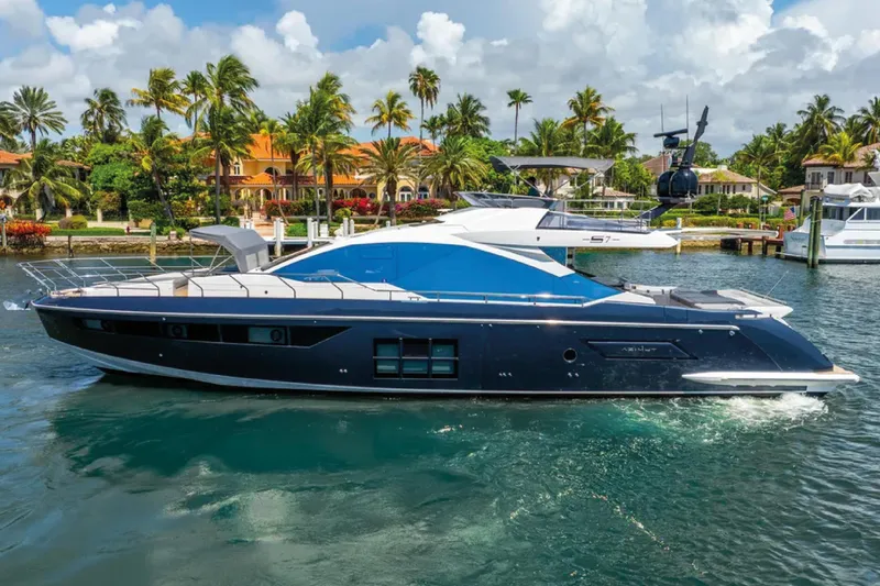 No Name Yacht Photos Pics 2019 Azimut S7 yacht cruising in a tropical marina with palm trees and luxury homes.