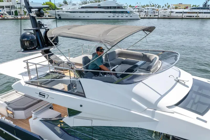 No Name Yacht Photos Pics 2019 Azimut S7 yacht with flybridge, docked in a marina, featuring sleek design and luxury seating.