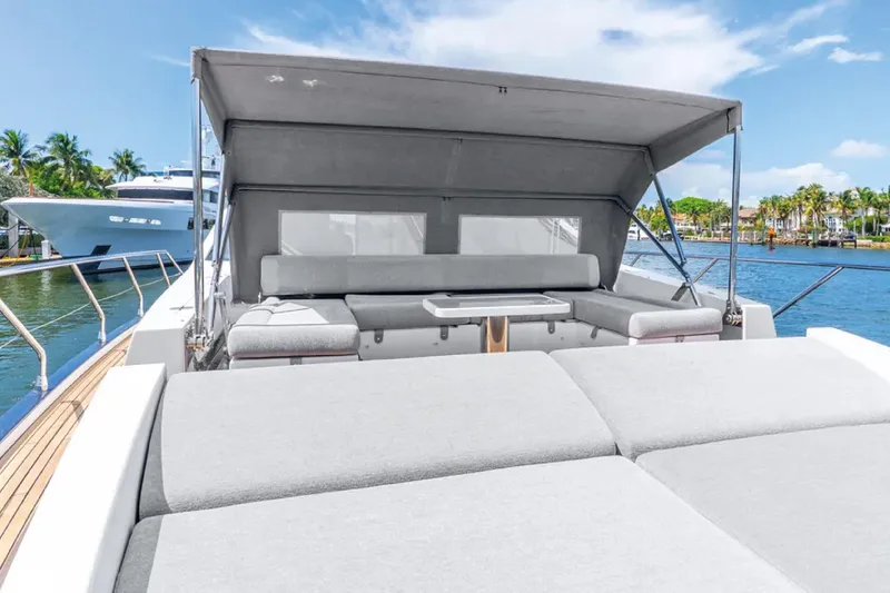 No Name Yacht Photos Pics 2019 Azimut S7 yacht with spacious deck and seating, docked by palm trees and water.