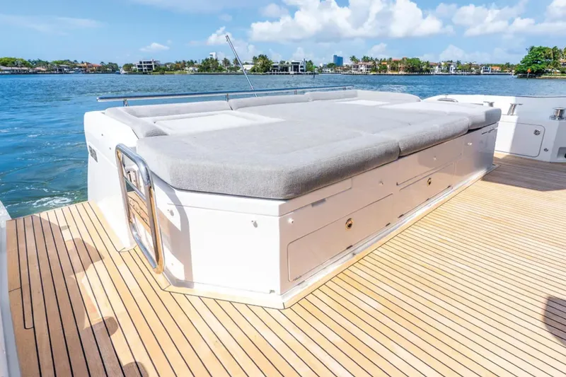 No Name Yacht Photos Pics 2019 Azimut S7 yacht deck with sunbed, overlooking serene waterfront.