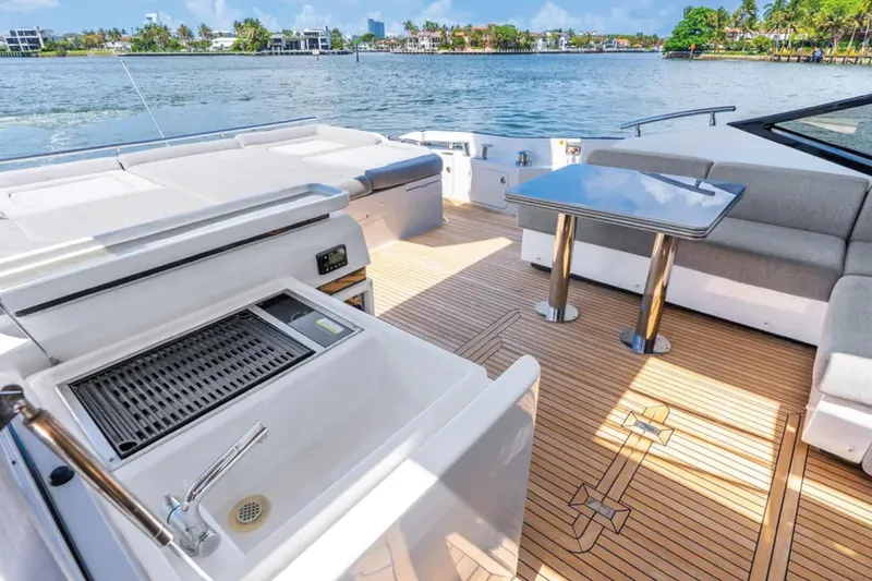 No Name Yacht Photos Pics Luxurious 2019 Azimut S7 yacht deck with seating, table, and grill, overlooking serene waters.