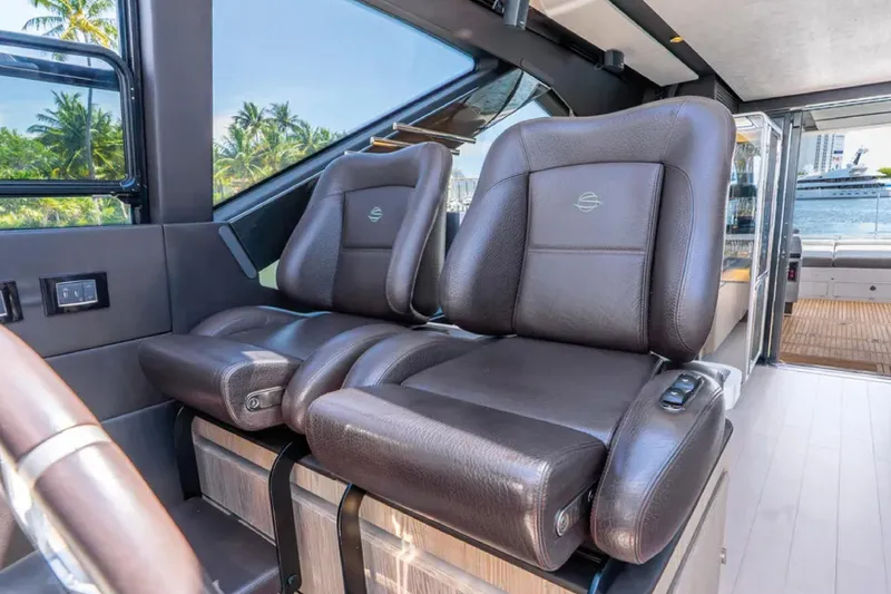 No Name Yacht Photos Pics Luxurious leather seats inside a 2019 Azimut S7 yacht, with a scenic ocean view.