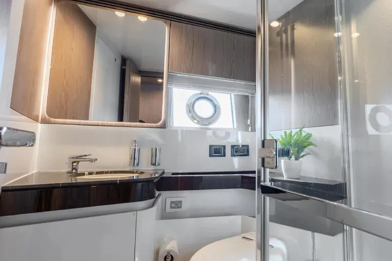 No Name Yacht Photos Pics Luxurious bathroom interior of 2019 Azimut S7 yacht with modern fixtures and porthole window.