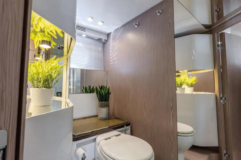 No Name Yacht Photos Pics Luxurious 2019 Azimut S7 yacht bathroom with modern decor and potted plants.