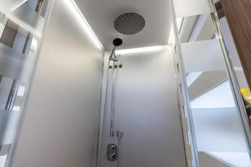 No Name Yacht Photos Pics Luxurious shower interior on a 2019 Azimut S7 yacht, featuring modern fixtures and lighting.
