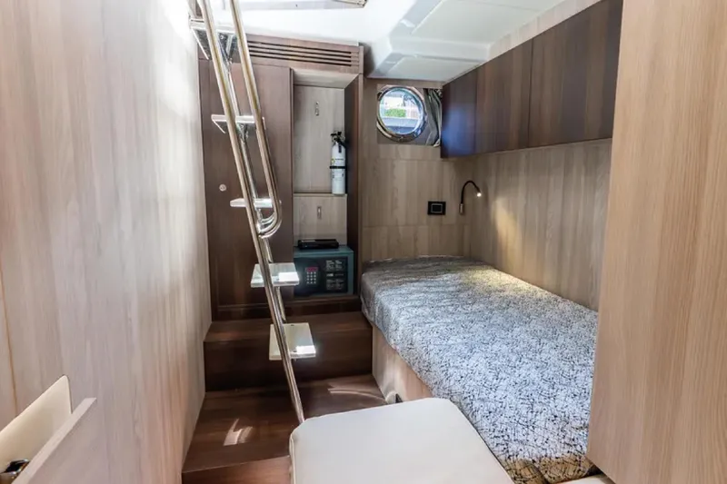 No Name Yacht Photos Pics 2019 Azimut S7 yacht cabin interior with bed, ladder, and porthole window.