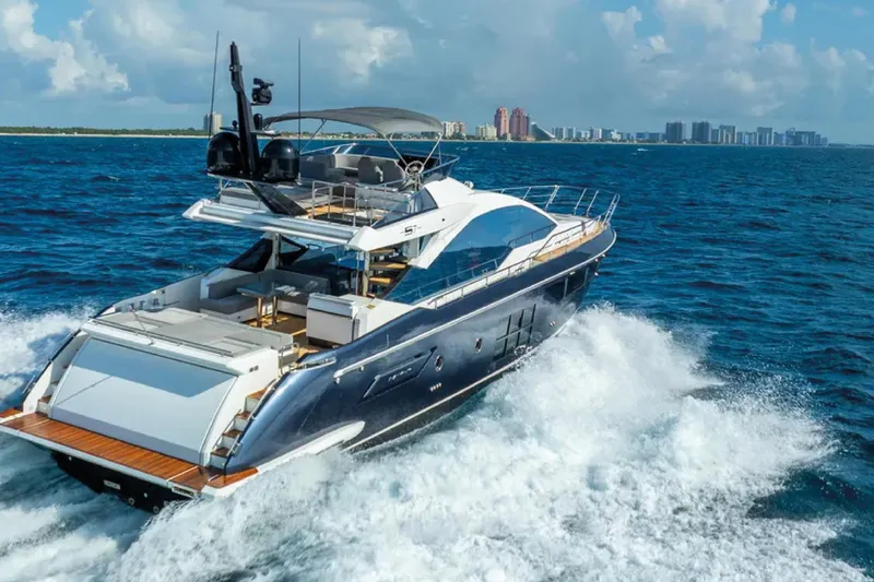 No Name Yacht Photos Pics Luxurious 2019 Azimut S7 yacht cruising on open sea with city skyline in background.
