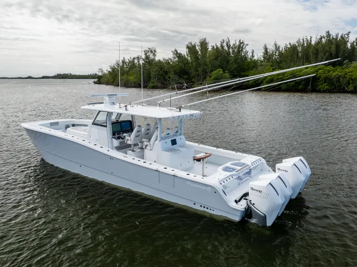  Yacht Photos Pics 2023 Freeman 43 boat on calm water, featuring dual outboard engines.