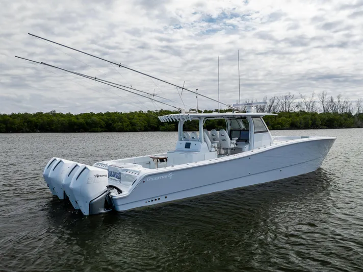  Yacht Photos Pics 2023 Freeman 43 boat on calm water with fishing rods and twin engines.