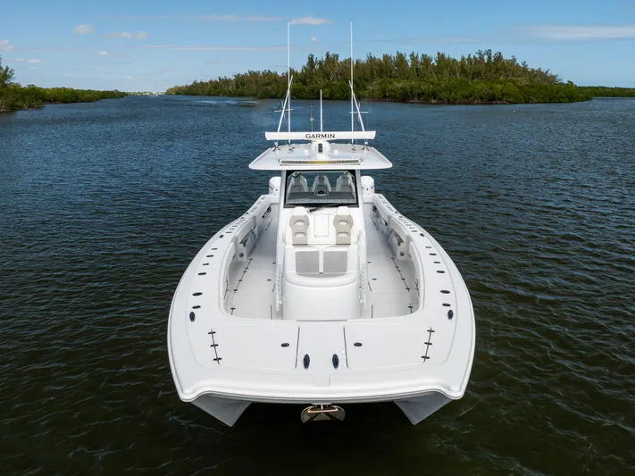  Yacht Photos Pics 2023 Freeman 43 boat on calm water, showcasing sleek design and spacious deck.