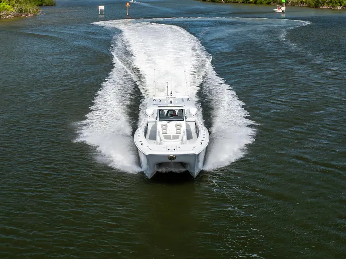  Yacht Photos Pics 2023 Freeman 43 boat cruising on a river, creating a wake behind.