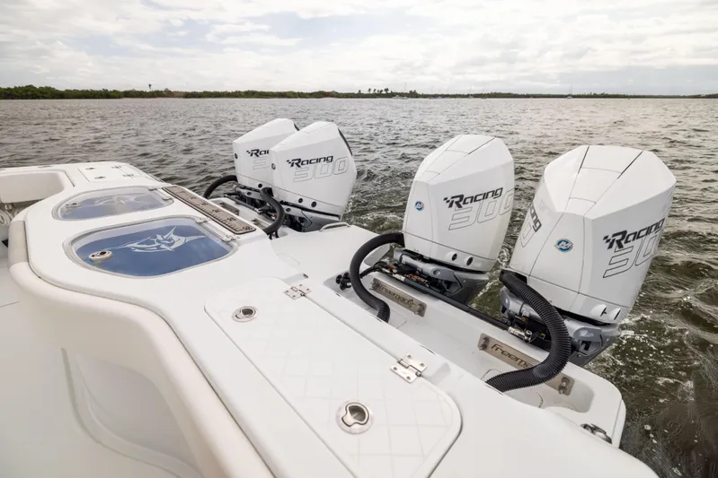  Yacht Photos Pics 2023 Freeman 43 boat with powerful outboard engines on open water.