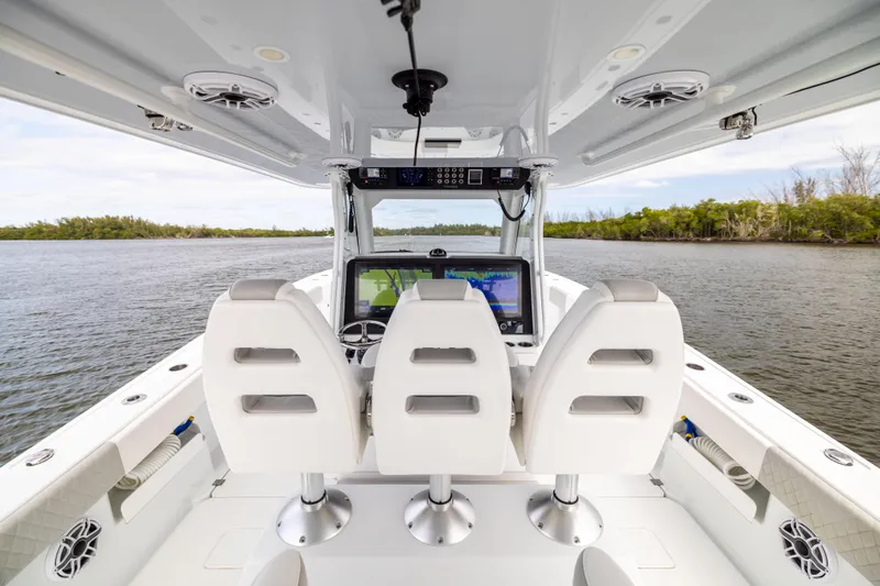  Yacht Photos Pics Interior view of 2023 Freeman 43 boat with three white seats and navigation screens.