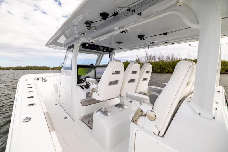  Yacht Photos Pics 2023 Freeman 43 boat interior with sleek white seating and modern controls.