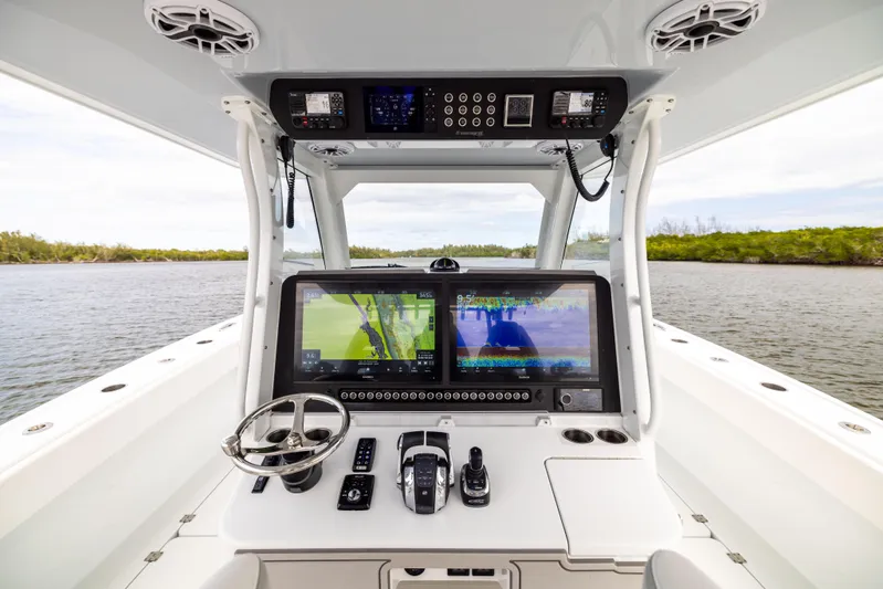  Yacht Photos Pics Freeman 43 boat cockpit with advanced navigation system, 2023 model, on a serene waterway.