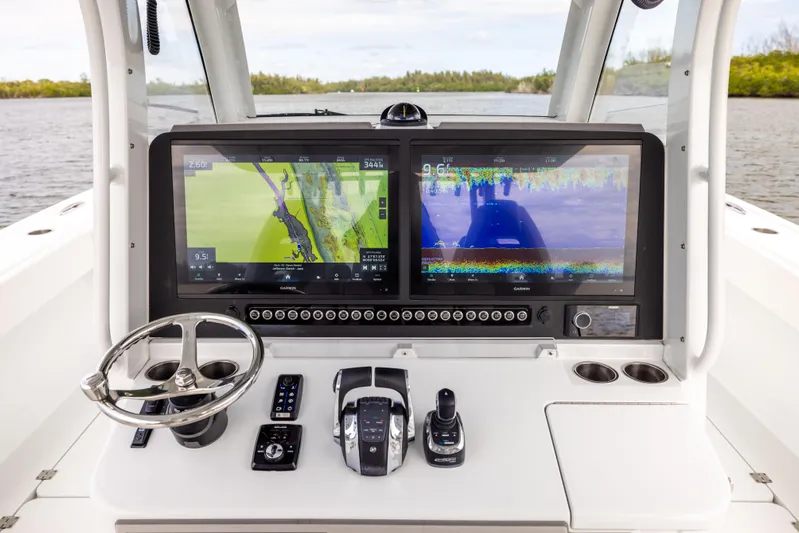  Yacht Photos Pics Freeman 43 boat dashboard with dual navigation screens, steering wheel, and controls, 2023 model.