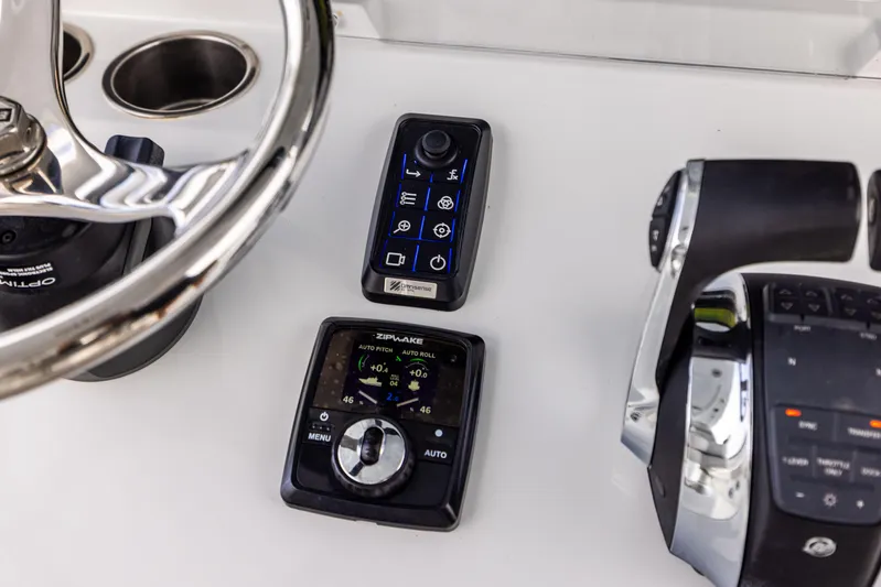  Yacht Photos Pics Control panel of a 2023 Freeman 43 boat with steering wheel and throttle.