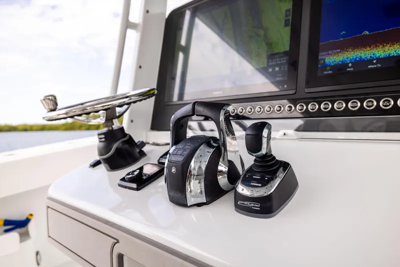  Yacht Photos Pics Control panel of 2023 Freeman 43 boat with steering wheel and navigation equipment.