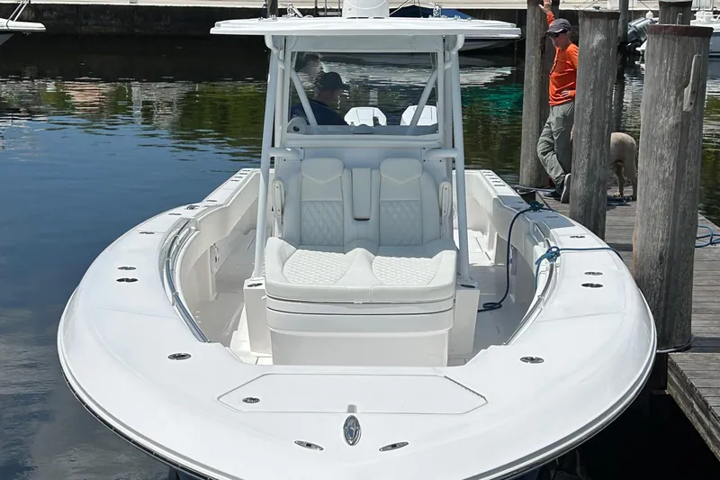  Yacht Photos Pics 2023 Invincible 36 Open Fisherman boat docked, featuring sleek design and spacious seating.