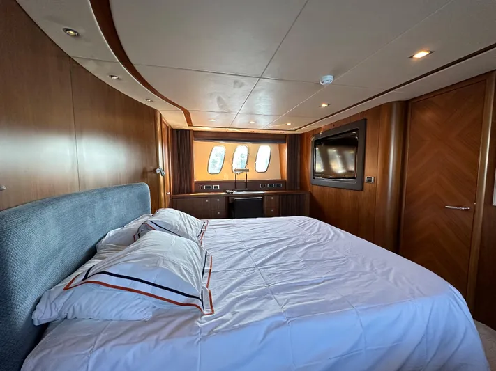 Low Profile Yacht Photos Pics Luxurious bedroom on a 2007 Sunseeker Predator 82 yacht with wood paneling and large windows.