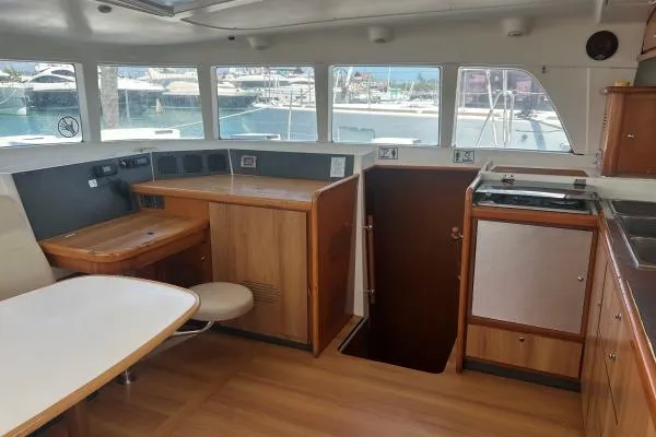 Dos Yacht Photos Pics Interior of 2005 Lagoon 440 catamaran with wood finish and large windows.
